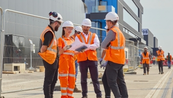 Group of men and women on a construction site