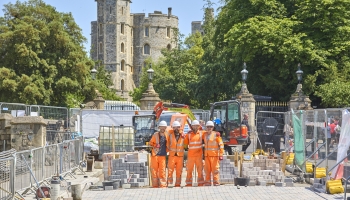 Picture of Highways employees in orange PPE, on site and smiling.